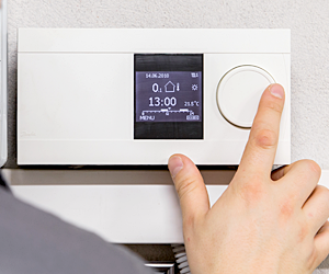 Engineer Adjusting Thermostat